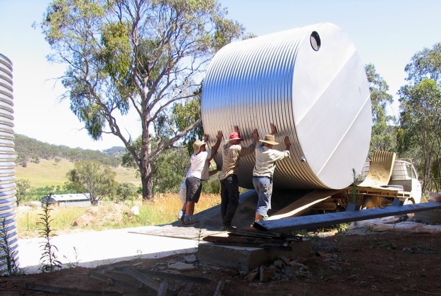 Rolling the second tank off the truck and into position - surprisingly easy, so long as you take it slow and get some friends to help