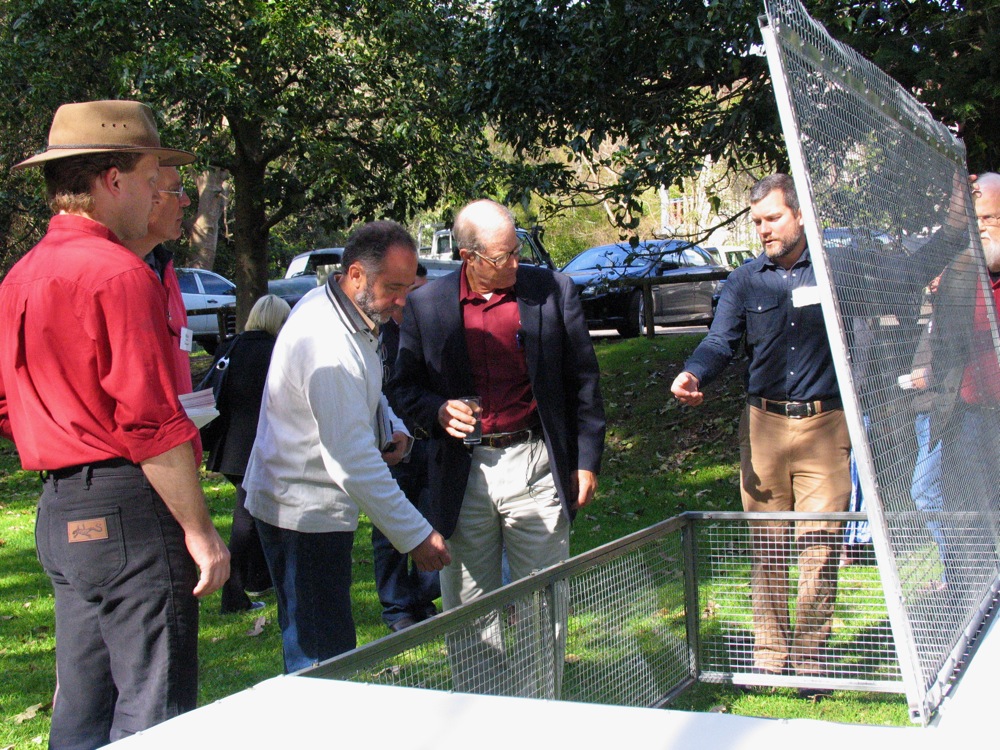 Nick of Milkwood gallantly demonstrating the tractor door to Joel, with Douglas St.Quintin (red shirt), who made the tractor, looking on 