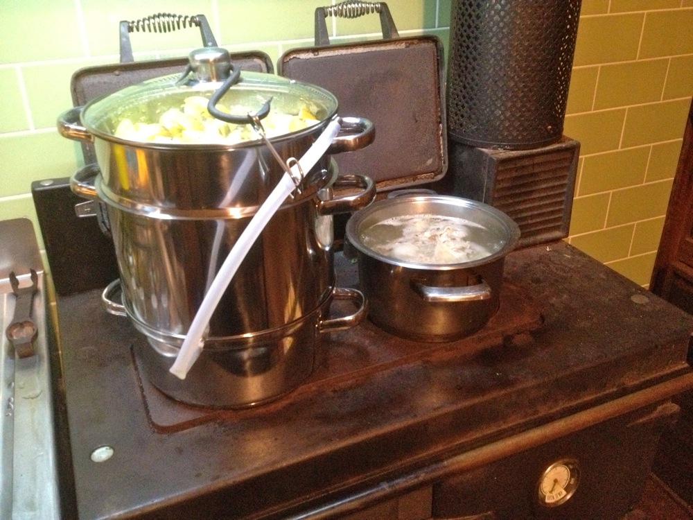 Steam juicer (and chicken stock) on the woodstove, bubbling away