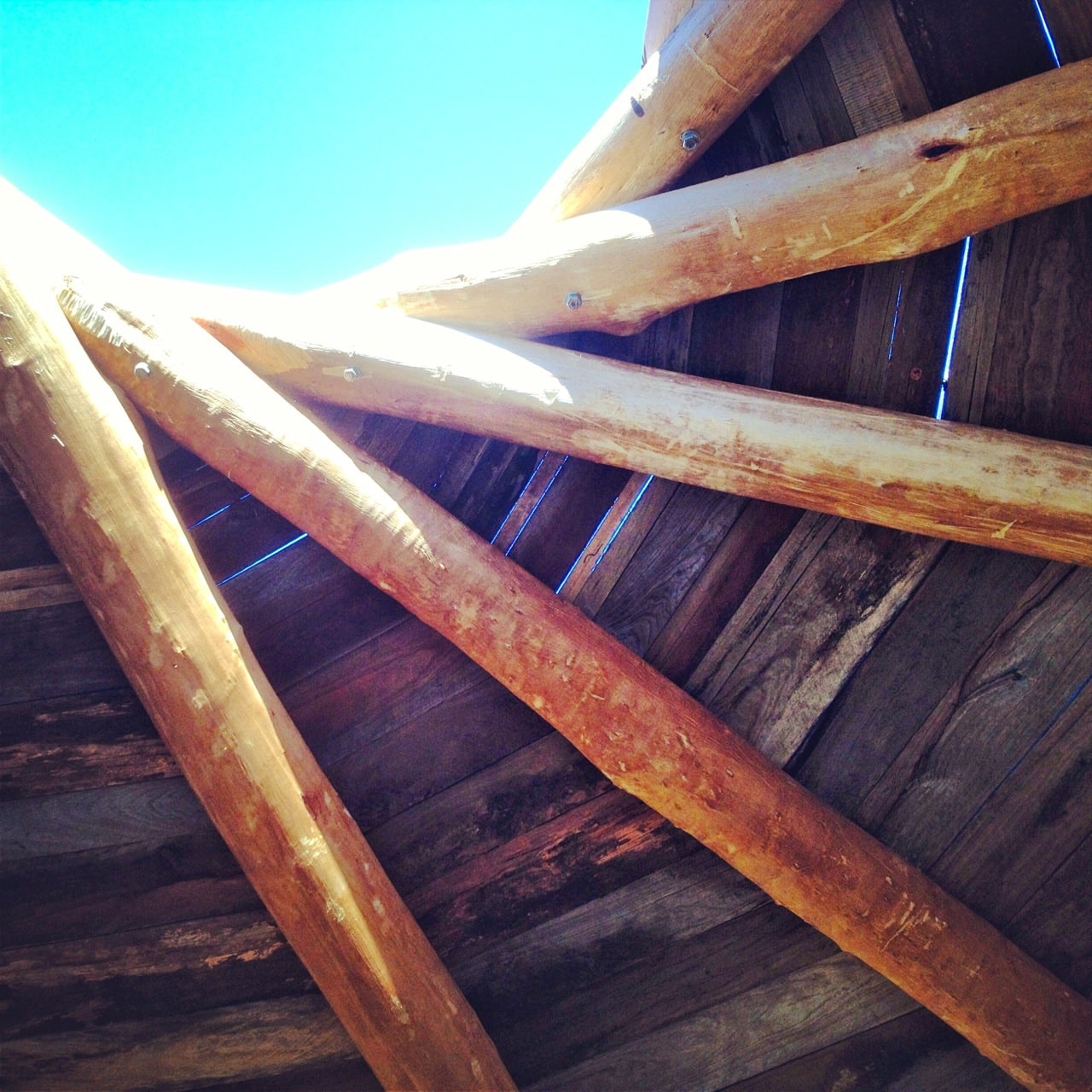 The ceiling - roundwood rafters with recycled hardwood board infill