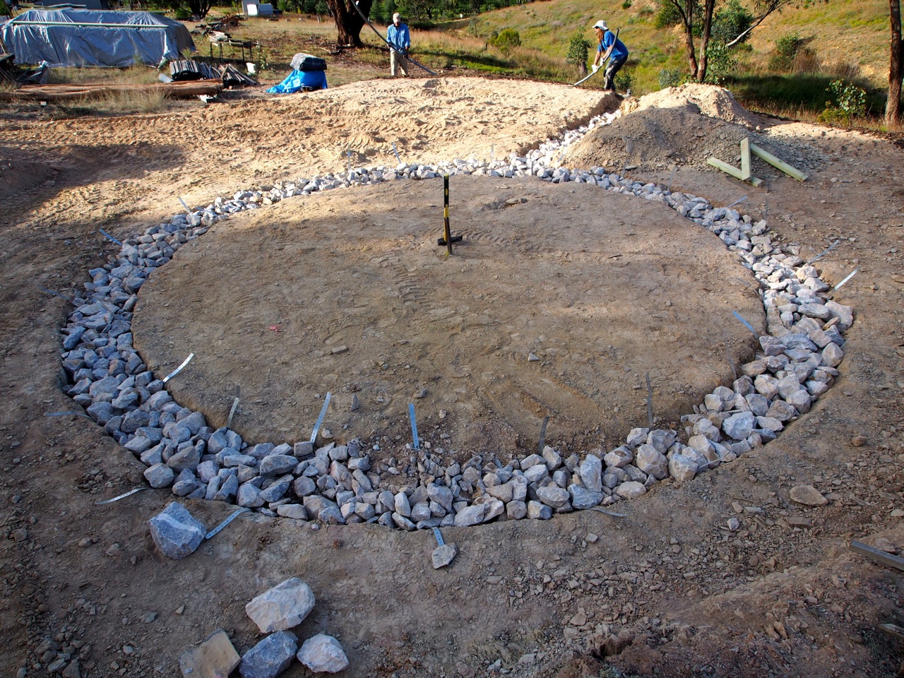 Rubble footings done - the strips of metal coming out will wrap around the wooden bottom plates of the walls