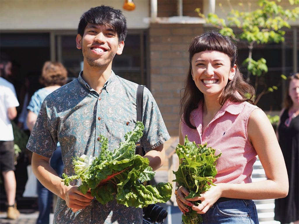 Two happy people smiling about their crop swap goodies.