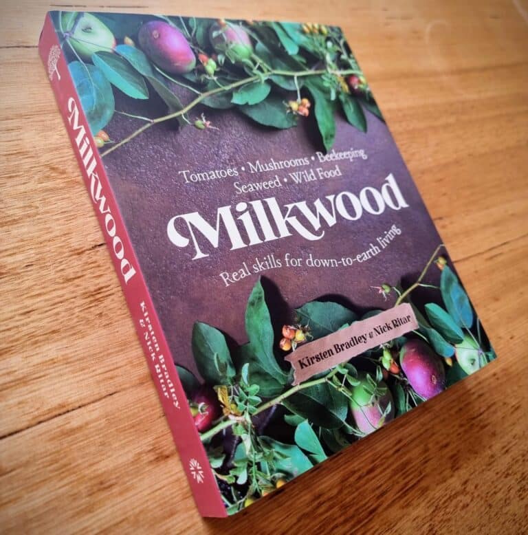 Milkwood standing on a wooden table, showing the spine and the front cover