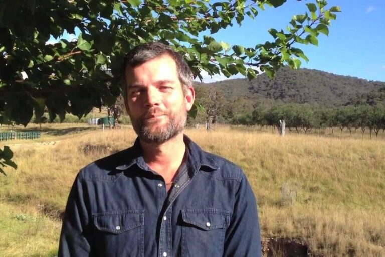 International Permaculture Day 2012 (video still) Nick Ritar standing in a sunny paddock under a tree