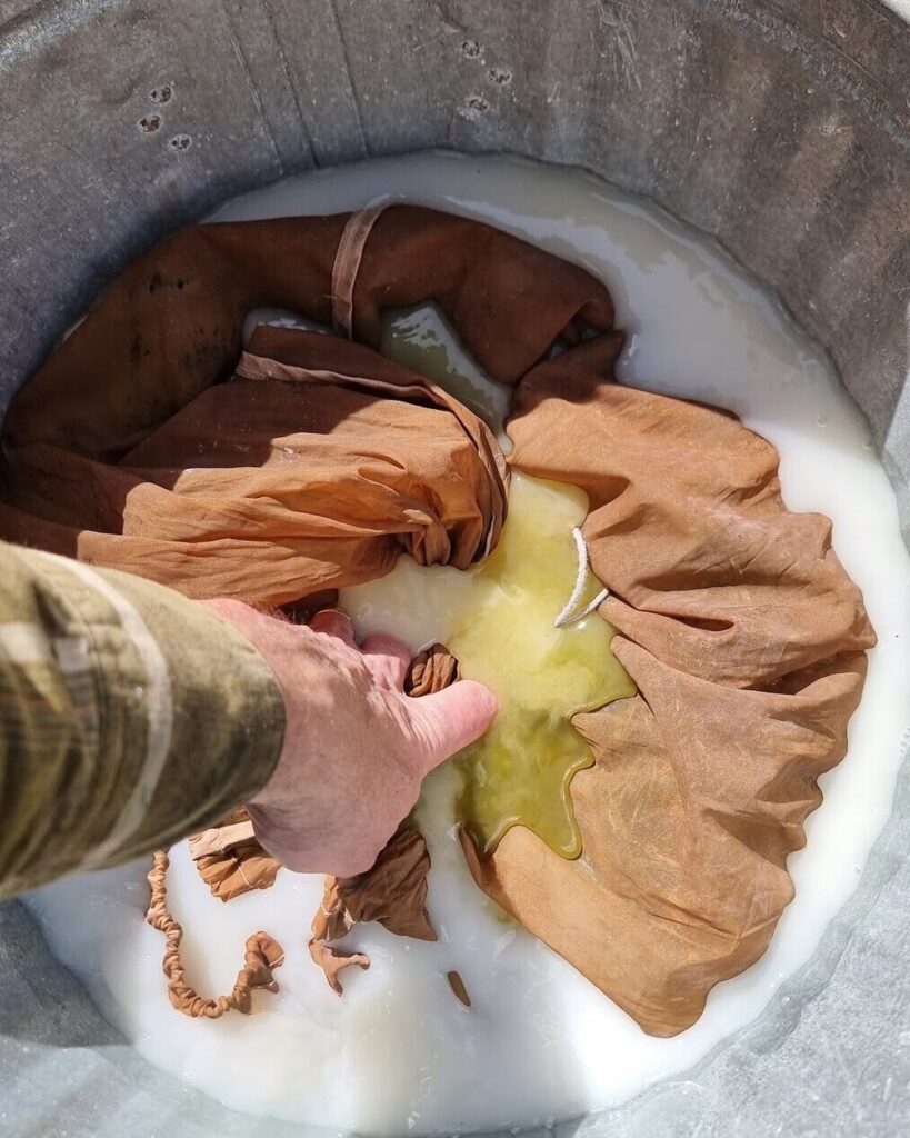 Squishing the bag down into the lime water